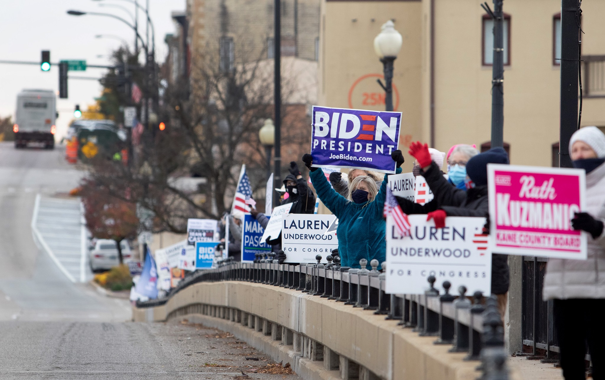 voters on a bridge promoting candidates