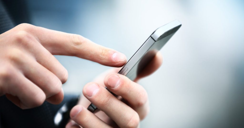 close up of a man using mobile smart phone